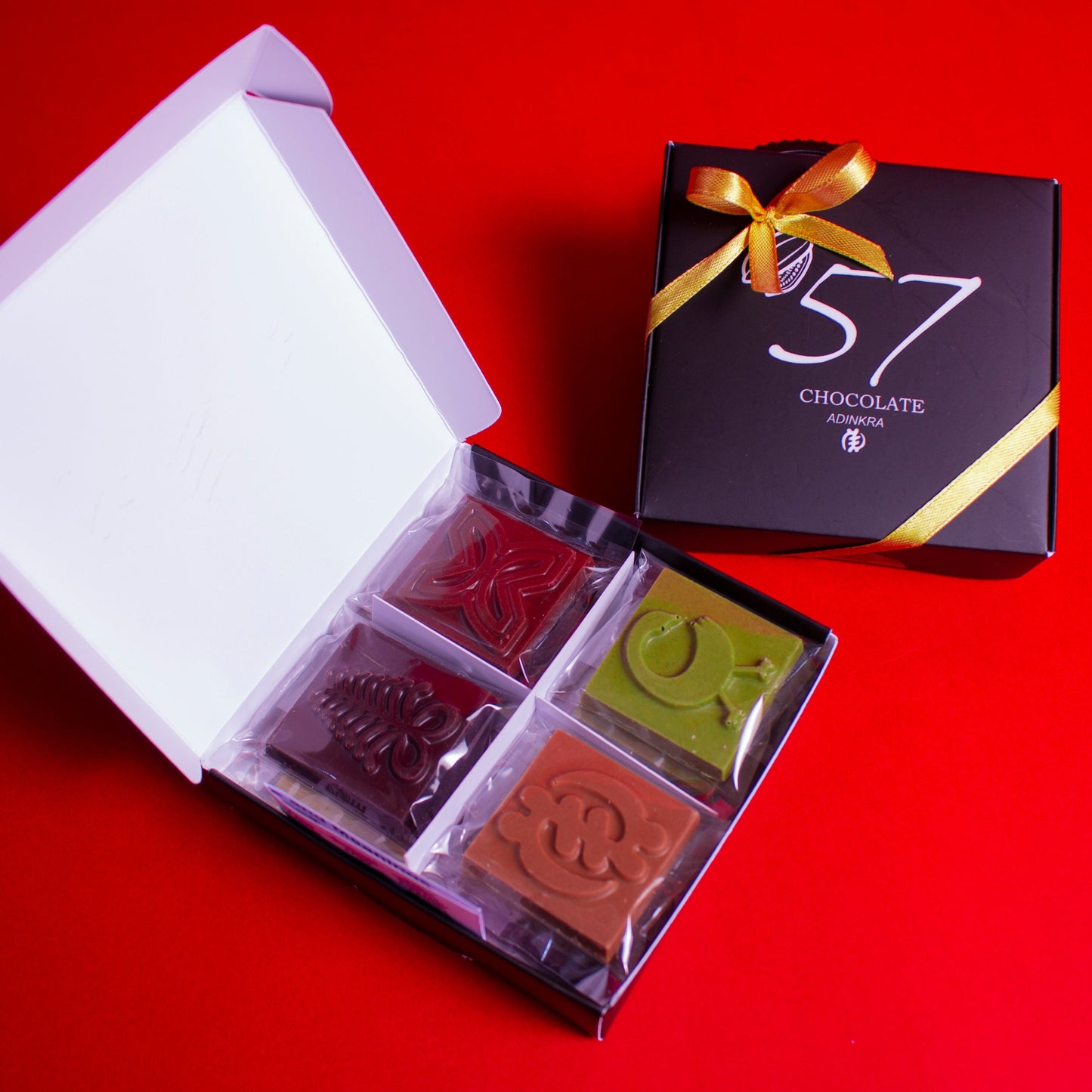 12 bite-sized adinkra chocolates made by '57 Chocolate 